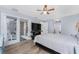 Bright main bedroom with hardwood floors, ceiling fan, and backyard access at 4529 Enid Ln, North Port, FL 34288