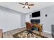 Nicely decorated home office with a closet, monitors, TV and wood-look laminate flooring at 4529 Enid Ln, North Port, FL 34288