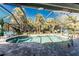 Sparkling screened-in pool area with stone pavers, lush tropical landscaping, and inviting lounge chairs at 4529 Enid Ln, North Port, FL 34288