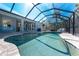 Backyard features a screened-in pool with deck and covered lanai for entertaining at 4529 Enid Ln, North Port, FL 34288