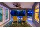 Relaxing screened-in lanai with seating overlooking a pool illuminated by blue lights at night at 4529 Enid Ln, North Port, FL 34288