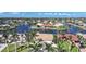 Waterfront homes with boat docks are set along canals in this sunny aerial view at 494 Monaco Dr, Punta Gorda, FL 33950