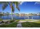 Tranquil backyard setting with a waterway view, tropical palm and stone landscaping at 494 Monaco Dr, Punta Gorda, FL 33950