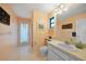 Bathroom featuring tiled floors, a vanity with white cabinets, a toilet, and a shower with glass doors at 494 Monaco Dr, Punta Gorda, FL 33950