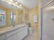Bright bathroom featuring a vanity with white cabinets, a toilet, and a shower with glass doors at 494 Monaco Dr, Punta Gorda, FL 33950
