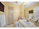 Bathroom featuring tiled floors, a vanity with white cabinets, a toilet, and a shower with glass doors at 494 Monaco Dr, Punta Gorda, FL 33950