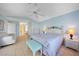 Bright bedroom with tiled floors, ceiling fan, access to an adjacent living area, and a walk-in closet at 494 Monaco Dr, Punta Gorda, FL 33950