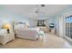 Cozy bedroom with light blue walls, tiled floors, a ceiling fan, and a door to the outside at 494 Monaco Dr, Punta Gorda, FL 33950