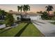 Charming home with a manicured lawn and driveway leading to an attached garage at 494 Monaco Dr, Punta Gorda, FL 33950