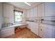 Bright laundry room boasts ample cabinet and counter space and a view at 494 Monaco Dr, Punta Gorda, FL 33950