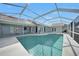 A spacious screened pool offers a luxurious outdoor experience with waterfront canal view at 494 Monaco Dr, Punta Gorda, FL 33950