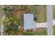 An aerial view showing the roof, the driveway, the fenced yard, and surrounding trees at 5113 Weatherton St, North Port, FL 34288