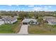 An aerial view of a home with a paved driveway, a fenced backyard, and lush greenery at 5113 Weatherton St, North Port, FL 34288