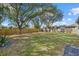 Spacious backyard with large shade trees and wooden fence at 5113 Weatherton St, North Port, FL 34288