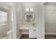Bright bathroom featuring a round mirror and a modern single sink vanity with tile backsplash at 5113 Weatherton St, North Port, FL 34288