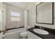 Bathroom featuring a shower-tub, toilet, vanity, and decorative tile at 5113 Weatherton St, North Port, FL 34288