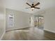 Bedroom featuring wood-look flooring, a ceiling fan and access to the lanai at 5113 Weatherton St, North Port, FL 34288