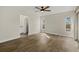 Sunlit bedroom showcasing wood-look floors and an adjacent bathroom at 5113 Weatherton St, North Port, FL 34288
