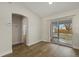 Sunlit dining area with wood floors and sliding glass door at 5113 Weatherton St, North Port, FL 34288