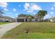 Well-kept single-story home with a brick driveway and a lush green lawn at 5113 Weatherton St, North Port, FL 34288