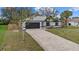 Exterior elevation of home featuring a paved driveway and a two-car garage at 5113 Weatherton St, North Port, FL 34288