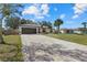 Attractive single-story home showcasing a brick driveway and neat landscaping at 5113 Weatherton St, North Port, FL 34288