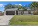 Charming single-story home featuring a well-manicured lawn and a two-car garage at 5113 Weatherton St, North Port, FL 34288