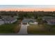 A twilight aerial of a charming single-story home with a fenced backyard and an expansive driveway at 5113 Weatherton St, North Port, FL 34288