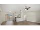 Open-concept living space with wood floors, neutral paint and stainless kitchen appliances at 5113 Weatherton St, North Port, FL 34288