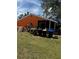 Untidy backyard view of an orange home at 5240 Malamin Rd, North Port, FL 34287