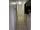Hallway featuring tile flooring, access to multiple rooms, and a utility area at 5240 Malamin Rd, North Port, FL 34287