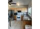 Well-lit kitchen with updated stainless steel appliances, granite countertops, and wood cabinets at 5240 Malamin Rd, North Port, FL 34287