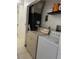Utility room features a washer, dryer, and storage shelves at 5240 Malamin Rd, North Port, FL 34287