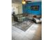 Inviting living room with modern tiled flooring, bright blue accent wall, and a comfy, oversized sectional at 5240 Malamin Rd, North Port, FL 34287