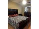 Spacious main bedroom with a dark wooden king bed, warm lighting, and hardwood floors at 5240 Malamin Rd, North Port, FL 34287