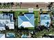 Beautiful aerial view of a bright, modern home with a backyard pool surrounded by lush, tropical landscaping and palm trees at 621 Trabue Ave, Punta Gorda, FL 33950