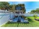 Backyard with a Spalding basketball hoop behind the seating area with lush green lawn at 621 Trabue Ave, Punta Gorda, FL 33950