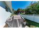 Backyard featuring a grill, white fence, and tropical plants, creating a private outdoor space at 621 Trabue Ave, Punta Gorda, FL 33950