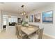 Elegant dining area with a rustic wood table, stylish decor, and an open view to the living room at 621 Trabue Ave, Punta Gorda, FL 33950