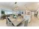 Bright dining room features stylish wood table, white walls, and lovely decor with living room in background at 621 Trabue Ave, Punta Gorda, FL 33950