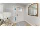 Inviting foyer featuring a white door, stylish mirror, and wood-look floors with a welcoming rug at 621 Trabue Ave, Punta Gorda, FL 33950