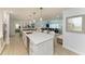 A kitchen island with white cabinets, a light countertop, and pendant lighting with barstool seating for four at 621 Trabue Ave, Punta Gorda, FL 33950