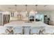 A kitchen island with white cabinets, a light countertop, and pendant lighting with barstool seating for four at 621 Trabue Ave, Punta Gorda, FL 33950