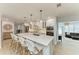 A kitchen island with white cabinets, a light countertop, and pendant lighting with barstool seating for four at 621 Trabue Ave, Punta Gorda, FL 33950