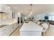 A kitchen island with white cabinets, a light countertop, and pendant lighting with barstool seating for four at 621 Trabue Ave, Punta Gorda, FL 33950