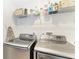 Modern laundry room featuring front-load washer and dryer with wire shelving above at 621 Trabue Ave, Punta Gorda, FL 33950