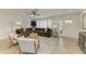 Comfortable living room featuring a large sectional sofa, stylish rug, and plantation shutters at 621 Trabue Ave, Punta Gorda, FL 33950