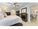 Tastefully designed main bedroom featuring a ceiling fan, ensuite bathroom and dining area in the background at 621 Trabue Ave, Punta Gorda, FL 33950