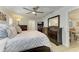 Tastefully designed main bedroom featuring a ceiling fan, ensuite bathroom and dining area in the background at 621 Trabue Ave, Punta Gorda, FL 33950