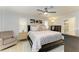 Serene main bedroom featuring a ceiling fan, accent pillows, and ensuite bathroom at 621 Trabue Ave, Punta Gorda, FL 33950